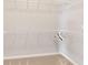 Walk-in closet featuring white wire shelving and neutral carpeting for organized storage at 6299 Sw 90Th St, Ocala, FL 34476