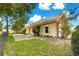 Fenced backyard with a small patio area and mature landscaping at 6551 Se 11Th Loop, Ocala, FL 34472