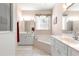 An elegant bathroom showcases double vanities, a soaking tub, and a separate glass door shower at 6551 Se 11Th Loop, Ocala, FL 34472
