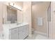 A serene bathroom featuring a large mirror, single sink vanity, and a glass-enclosed shower at 6551 Se 11Th Loop, Ocala, FL 34472