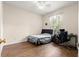 Relaxing bedroom with wood-look floors, ceiling fan, workstation, and natural light from the window at 6551 Se 11Th Loop, Ocala, FL 34472