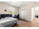 A comfortable bedroom with wood-look floors and a view of the closet is the perfect retreat at 6551 Se 11Th Loop, Ocala, FL 34472