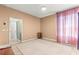 Bright bedroom with tiled floors, neutral tones, and natural light coming through the pink curtains at 6551 Se 11Th Loop, Ocala, FL 34472