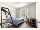 This bright bedroom includes a desk, ceiling fan, and a large window offering natural light at 6551 Se 11Th Loop, Ocala, FL 34472