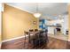 Dining area features stylish chandelier, wood floors and view into kitchen at 6551 Se 11Th Loop, Ocala, FL 34472