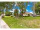 Exterior view of the side of the home featuring lush landscaping and a fenced backyard at 6551 Se 11Th Loop, Ocala, FL 34472