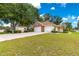 Spacious home featuring a two-car garage, side shed and a well-maintained lawn at 6551 Se 11Th Loop, Ocala, FL 34472