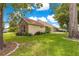 Exterior view of the side of the home featuring lush landscaping and a fenced backyard at 6551 Se 11Th Loop, Ocala, FL 34472