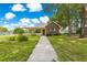 Inviting home with a brick facade, front porch, and walkway leading to the entrance at 6551 Se 11Th Loop, Ocala, FL 34472