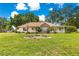 Charming one-story home featuring a brick facade, inviting front porch, and lush green lawn at 6551 Se 11Th Loop, Ocala, FL 34472