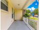 Comfortable front porch with a blue door, offering a relaxing outdoor space at 6551 Se 11Th Loop, Ocala, FL 34472