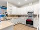Modern kitchen with white cabinetry, stainless steel appliances, and tile flooring at 6551 Se 11Th Loop, Ocala, FL 34472