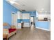 Comfortable living room with tile floors, white trim, and doorway to the kitchen at 6551 Se 11Th Loop, Ocala, FL 34472