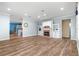 Open-concept living room with a cozy brick fireplace and built-in shelving for ample storage at 6551 Se 11Th Loop, Ocala, FL 34472
