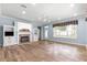 Cozy living room with brick fireplace, built-in cabinets, and large windows for plenty of natural light at 6551 Se 11Th Loop, Ocala, FL 34472