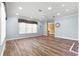 Bright living room boasts wood floors, modern ceiling fan, and large windows with decorative valance at 6551 Se 11Th Loop, Ocala, FL 34472
