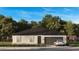 Charming one-story home with a two-car garage, stone accents, and professional landscaping at 6859 Sw 128Th Pl, Ocala, FL 34473