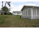 Spacious backyard featuring a screened-in patio and lush green lawn, perfect for outdoor entertaining at 8650 Sw 108Th Pl, Ocala, FL 34481