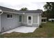 Backyard features a patio area, siding, and a sunroom attached to the house at 8650 Sw 108Th Pl, Ocala, FL 34481