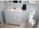 Bathroom features include a vanity, sink, mirror, towel rack and toilet at 8650 Sw 108Th Pl, Ocala, FL 34481