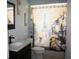 Bathroom featuring dark wood vanity, white countertop, and shower with a Parisian theme at 8650 Sw 108Th Pl, Ocala, FL 34481