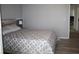 Bedroom with bed featuring gray geometric patterned bedding and view into adjacent room at 8650 Sw 108Th Pl, Ocala, FL 34481