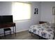 Cozy bedroom with bright window, floral bedding, and TV on wood stand at 8650 Sw 108Th Pl, Ocala, FL 34481