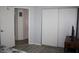 Bedroom featuring a sliding door closet and view into adjacent room at 8650 Sw 108Th Pl, Ocala, FL 34481