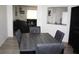 A dining area featuring a gray wood table with seating and a view into the adjacent living room at 8650 Sw 108Th Pl, Ocala, FL 34481