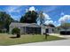 Charming single-story home featuring a screened-in porch, well-manicured lawn, and attached garage at 8650 Sw 108Th Pl, Ocala, FL 34481