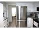 Updated kitchen features modern stainless-steel appliances, sleek countertops, and white cabinetry at 8650 Sw 108Th Pl, Ocala, FL 34481