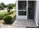 Enclosed porch featuring tiled flooring, a screened-in enclosure, and views of the landscaped yard at 8650 Sw 108Th Pl, Ocala, FL 34481