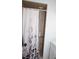 Bathroom features a shower with decorative curtain, shower head and grab bar at 8650 Sw 108Th Pl, Ocala, FL 34481