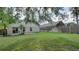 Large grassy backyard with patio and privacy fence, ideal for outdoor entertaining at 949 Woodsong Way, Clermont, FL 34714