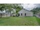 Spacious backyard featuring a well-maintained lawn, privacy fence and mature shade trees at 949 Woodsong Way, Clermont, FL 34714