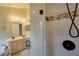 Bathroom features double vanity, glass shower, and decorative tile at 949 Woodsong Way, Clermont, FL 34714