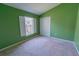 Bright bedroom with carpet, window, and large closet at 949 Woodsong Way, Clermont, FL 34714