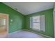 Bright bedroom features a large window with white shutters and light-colored carpet at 949 Woodsong Way, Clermont, FL 34714