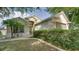 Inviting home exterior features a well-kept lawn, lush shrubbery, and an arched entry at 949 Woodsong Way, Clermont, FL 34714