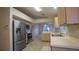 Functional kitchen boasts stainless steel appliances, plenty of counter space, and tiled floors at 949 Woodsong Way, Clermont, FL 34714