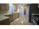 Well-lit kitchen showcases tiled floor, stainless steel appliances, and ample counter space at 949 Woodsong Way, Clermont, FL 34714