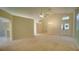 Bright and airy living room features high ceilings, carpet, ceiling fan, and entry to the home at 949 Woodsong Way, Clermont, FL 34714