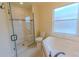 Bathroom with glass enclosed shower, tub, and tile floor at 949 Woodsong Way, Clermont, FL 34714
