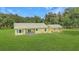 Aerial view of a sprawling property with green lawns and multiple buildings at 975 Cr 542E, Bushnell, FL 33513