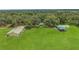 Aerial view of an expansive property with lush greenery and well-maintained buildings at 975 Cr 542E, Bushnell, FL 33513