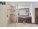 Bathroom features a glass-enclosed shower, double sinks, and tile flooring at 975 Cr 542E, Bushnell, FL 33513