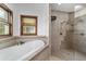 Close up of a soaking tub and walk-in shower with tile surround at 975 Cr 542E, Bushnell, FL 33513