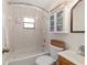 The bathroom features a tub with shower, a cabinet for storage, and a vanity sink at 975 Cr 542E, Bushnell, FL 33513