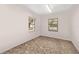 This bedroom features two windows and neutral paint, offering a cozy, blank canvas at 975 Cr 542E, Bushnell, FL 33513