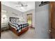 Bedroom with neutral paint, carpet, a queen bed, and a wood-framed window at 975 Cr 542E, Bushnell, FL 33513